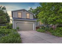 Charming two-story home with a well-maintained lawn, mature trees, and an attached two-car garage at 284 S Lincoln Ave, Louisville, CO 80027