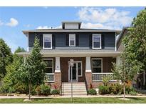 Charming two-story home with a welcoming front porch and well-maintained landscaping at 10109 E 28Th Ave, Denver, CO 80238