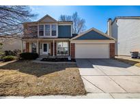 Charming two-story home featuring a brick facade and a well-maintained front yard in a suburban setting at 10842 W 100Th Dr, Westminster, CO 80021