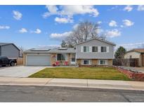 Charming two-story home with well-maintained lawn and a two car garage at 4428 E 118Th Ave, Thornton, CO 80233