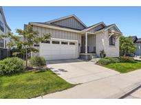 Charming home with a two-car garage and landscaped front yard at 11253 Moondance Trl, Littleton, CO 80125