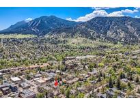 Stunning aerial view of the property nestled in a lush, green neighborhood with a mountain backdrop at 753 Pearl St, Boulder, CO 80302
