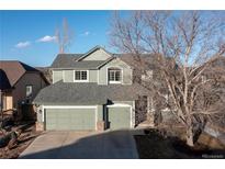 Traditional two-story home boasts a well-manicured front yard, three-car garage, and neutral color palette at 3981 Starflower Rd, Castle Rock, CO 80109