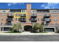 Spacious condo building featuring black balconies, lovely trees, and a convenient drive-in garage at 640 11Th St # 302, Golden, CO 80401