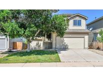 Charming two-story home with a well-maintained front yard and a two-car garage at 5483 Ben Park Cir, Parker, CO 80134
