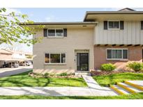 Charming two-story home featuring a well-maintained lawn and brick accents at 12648 W Virginia Ave, Lakewood, CO 80228