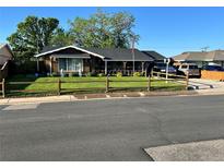 Charming single-story home with a well-maintained lawn and a covered front porch at 840 Essex Dr, Denver, CO 80229