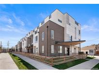 Modern townhome showcasing a sleek architectural style, complemented by well-manicured lawn and inviting walkway at 3520 W Conejos Pl # 11, Denver, CO 80204