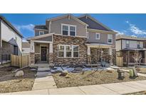 Charming two-story home featuring a stone facade, covered porch, and well-maintained landscaping in a vibrant community at 745 N Tempe St, Aurora, CO 80018
