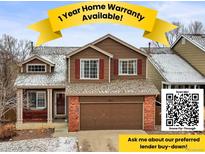 Charming two-story home with brown siding, brick accents, and a 1-year home warranty available at 951 Timbervale Trl, Highlands Ranch, CO 80129