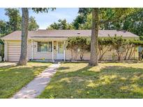 Charming single-story home with a well-maintained lawn and mature trees in a tranquil setting at 2922 S Cherry Way, Denver, CO 80222