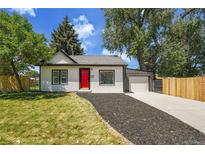 Charming single-story home with a red front door, well-manicured lawn, and an attached one car garage at 8801 E 16 Ave, Denver, CO 80220