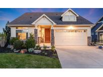 Charming single-Gathering home featuring a well-manicured lawn and a two-car garage at 19688 E 52Nd Ave, Denver, CO 80249