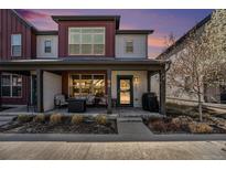 Charming two-story townhome featuring a cozy front porch with seating, great for relaxing outdoors at 5251 Central Park Blvd, Denver, CO 80238