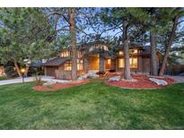 Charming two-story brick home with well-manicured lawn and mature trees at 7717 S Grape Ct, Centennial, CO 80122