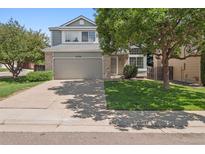 Charming two-story home featuring a well-maintained yard and attached two-car garage in a quiet neighborhood at 20396 E Berry Pl, Centennial, CO 80015