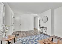 Light and airy entryway with a view into the living room at 3150 S Jasper Way, Aurora, CO 80013