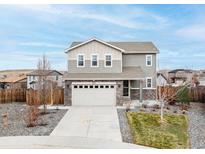 Charming two-story home with a two-car garage, stone accents, and well-maintained landscaping at 3918 S Rome Ct, Aurora, CO 80018