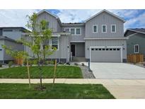 Charming two-story home with a well-manicured lawn and attached two car garage at 2548 Lupton Ln, Lafayette, CO 80026