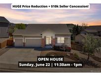 Charming one-story home featuring a well-manicured front yard, two-car garage, and inviting entryway at 1034 Halfmoon Dr, Castle Rock, CO 80104