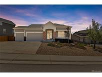 Attractive single-Gathering home with well-maintained landscaping, a three-car garage and a welcoming entrance at 1034 Halfmoon Dr, Castle Rock, CO 80104