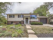 Ranch style home with mature landscaping and attached garage at 8912 Oberon Rd, Arvada, CO 80004