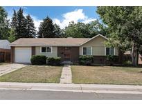 Charming single-story home with brick accents, tidy landscaping, and an attached one-car garage at 867 S Grape St, Denver, CO 80246