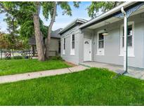 Charming gray home with a well-manicured lawn and a welcoming white front door at 2737 N Marion St, Denver, CO 80205