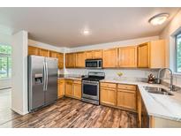 Bright kitchen boasts stainless steel appliances, light wood cabinets, and stylish countertop at 1842 Reliance Cir, Superior, CO 80027