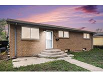 Charming single story brick home with a well-maintained front yard and concrete steps to the front door at 547 S 3Rd Avenue, Brighton, CO 80601