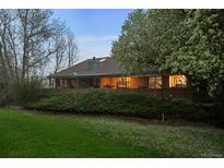 Expansive brick home with beautiful lawn, mature trees, and covered patio at 15220 E Caley Ave, Centennial, CO 80016