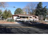 Ranch style home with carport, mature trees, and well-maintained landscaping at 9585 Brooks Dr, Arvada, CO 80004