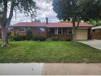 Charming brick home with a well-manicured lawn and mature trees at 6961 E Arkansas Ave, Denver, CO 80224