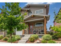 Charming two-story home featuring a welcoming front porch and a beautifully landscaped front yard at 21451 E 60Th Ave, Aurora, CO 80019