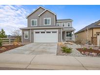 Charming two-story home with a two car garage and landscaped front yard at 9021 Swan River St, Littleton, CO 80125