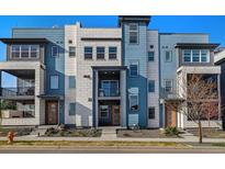Modern townhome showcasing a three-story facade with varied textures and complementary blue and gray hues at 1565 W 67Th Ave, Denver, CO 80221