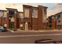 Modern condo with brick facade and multiple balconies in a convenient neighborhood setting at 14301 E Tennessee Ave # 109, Aurora, CO 80012
