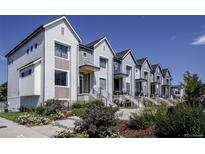 Charming row of two-story homes with modern facades, landscaping, and a clear blue sky at 242 Clementina St, Louisville, CO 80027
