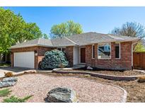 Charming single-story brick home featuring a well-manicured front yard and a two-car garage at 2072 Skylark Ct, Longmont, CO 80503