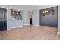 Modern living room features wood floors and a decorative wall at 23744 E Ida Pl # E, Aurora, CO 80016