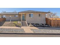 Charming brick home featuring a well-manicured front yard and inviting entrance at 3753 N Cook St, Denver, CO 80205