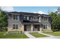 Charming townhome with stone accents, a well-manicured lawn, and inviting covered front porches at 15228 Detroit St, Thornton, CO 80602
