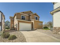 Inviting two-story home with a two-car garage and lovely landscaping at 5624 Killdeer St, Brighton, CO 80601