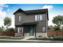 Charming two-story home featuring a green front door, gray siding, and a well-manicured lawn at 5762 N Jebel Way, Aurora, CO 80019