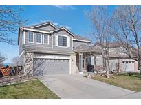 Two-story home features a two-car garage, landscaped yard, and well-maintained exterior at 11671 Elkhart, Brighton, CO 80603