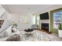Bright living room features a fireplace and neutral color palette at 8710 Carr Loop, Arvada, CO 80005
