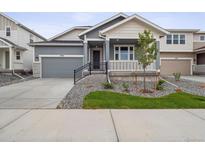 Charming single-Gathering home with a well-manicured lawn, inviting curb appeal and a covered front porch at 45916 Gentry Ave, Bennett, CO 80102