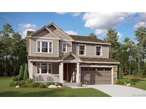 Charming two-story home features a covered porch, stone accents, and an attached two-car garage at 39141 Anthony St, Elizabeth, CO 80107