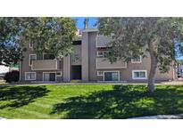 Exterior shot of building with number 19 in the center, and large trees framing the sides of the building at 10150 E Virginia Ave # 308, Denver, CO 80247