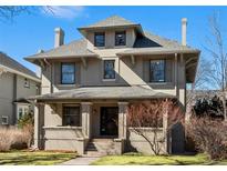Inviting exterior featuring a covered porch, brick facade, and well-maintained landscaping at 637 N Franklin St, Denver, CO 80218